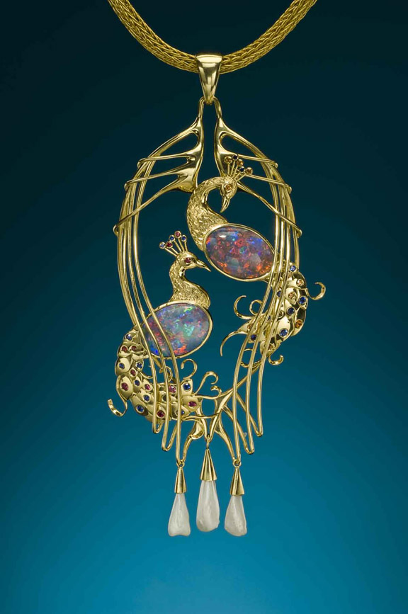 22k/18k hand fabricated Peacock Pendant. The piece is accented with two black opals from the Moonshine Field at Lightning Ridge as well as rubies, sapphires, natural Mississippi pearls and spessartite garnets. Designed and handmade by R. W. Wise, Goldsmiths, Michael Corneau, designer/craftsman.