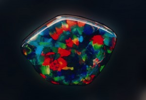 Millenium, a 25 carat Harlequin opal sourced by Cody Opal and sold several years ago by R. W. Wise, Goldsmiths  The gem has the the double virtues of large angular blocks of color and a dominent red which is the rarest hue in opal.